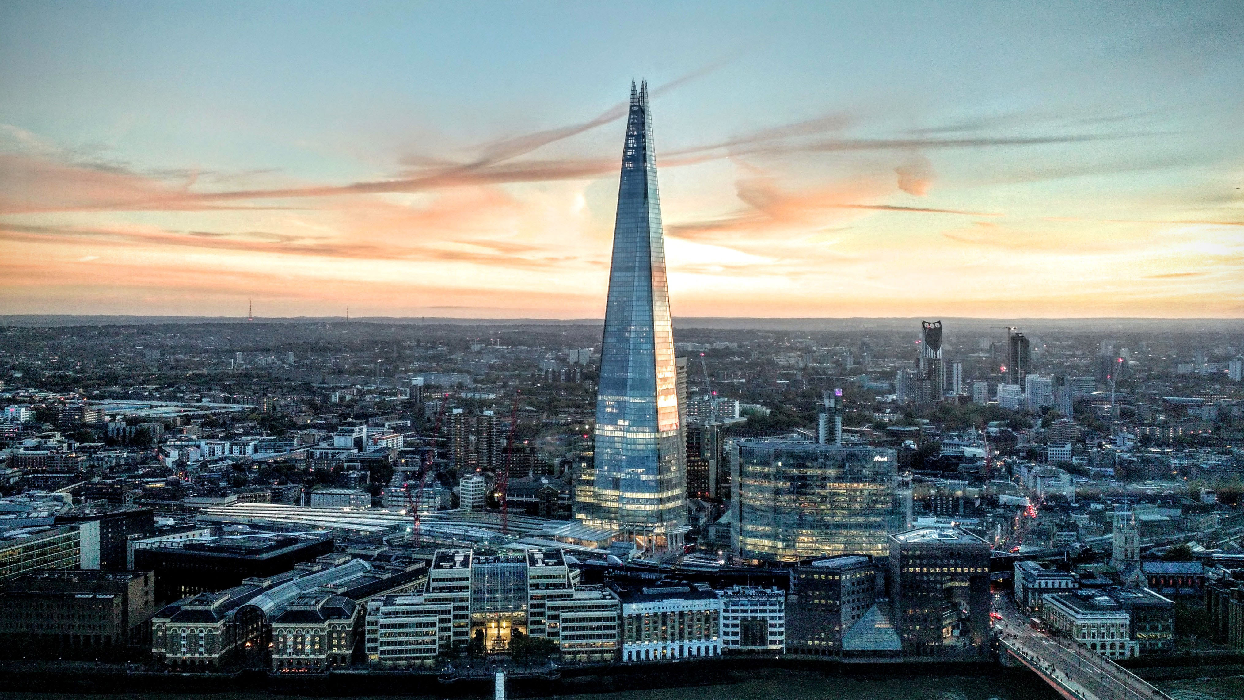 The London skyline at sunset centering The Shard (photo by Fred Moon on Unsplash)